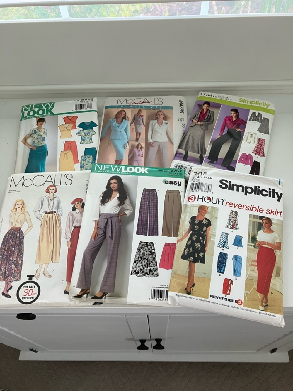 Six uncut sewing patterns women’s separate pants and skirts. Size is 6–18.